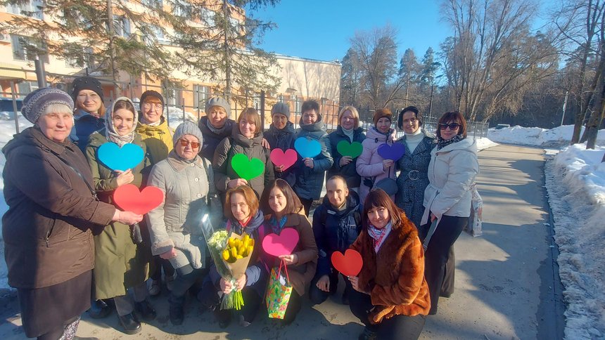The believer and her husband surrounded by friends near the court building