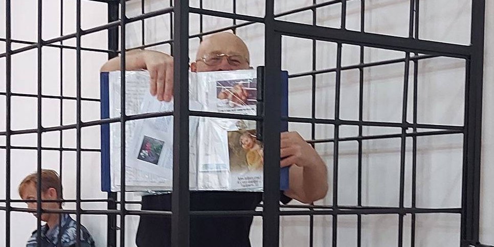 In the courtroom, Valeriy Baylo is showing letters that he received during his imprisonment